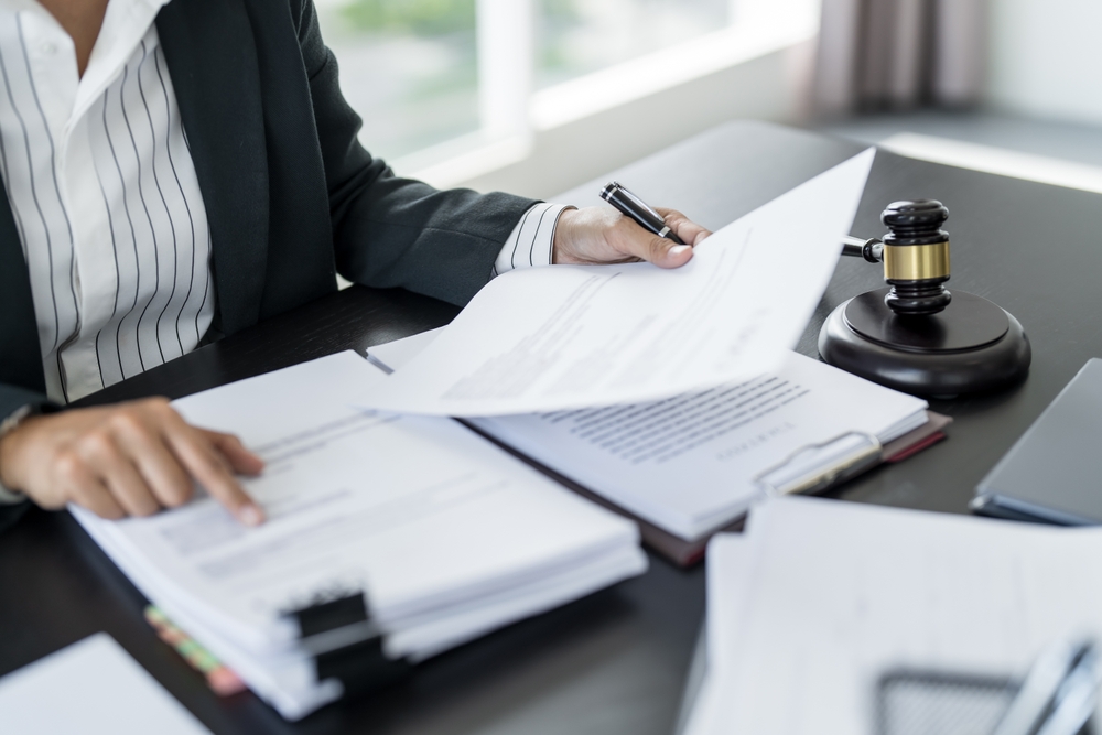 Gavel, legal documents, and a nursing home in the background symbolizing resident legal protections.
